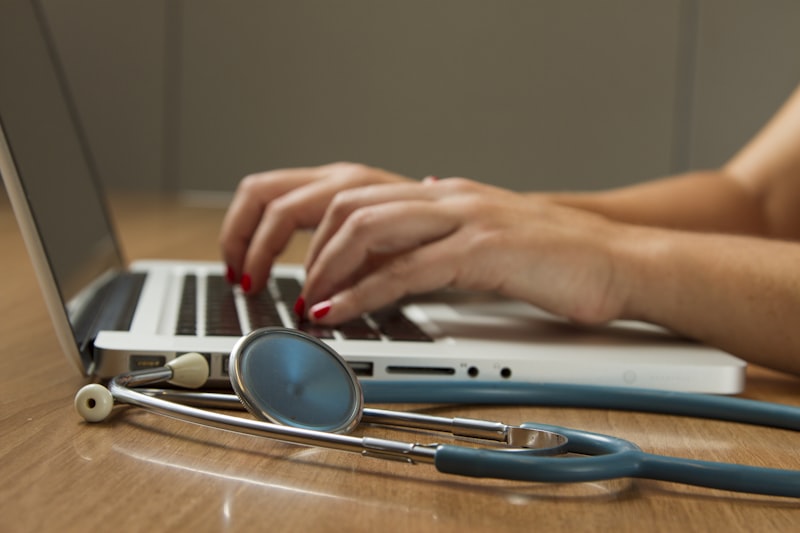 Practitioner reviewing structured health data and assessment notes for a root-cause diagnostic review